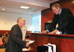 San Francisco Parole Reentry Court Judge Jeffrey Tauber (ret.), presents a progoram participant with an award